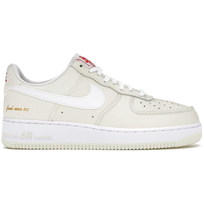 Beige sneaker with white swoosh logo on a white background