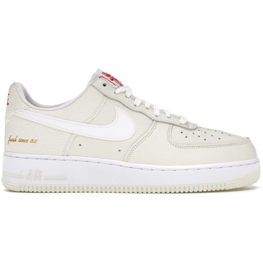 Beige sneaker with white swoosh logo on a white background