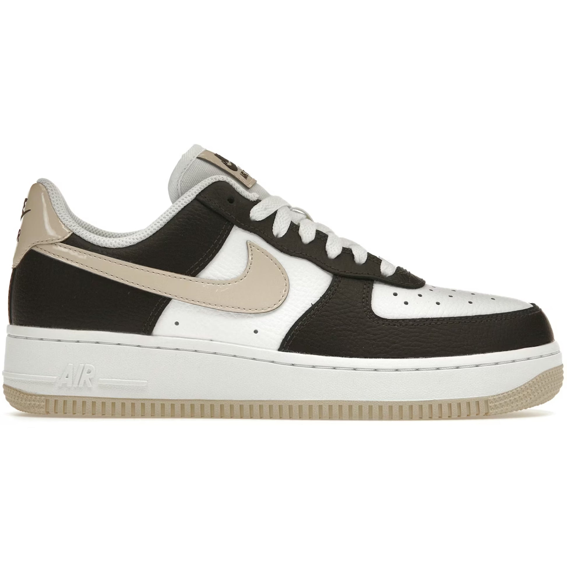 Black and white sneaker with a tan swoosh logo on a white background