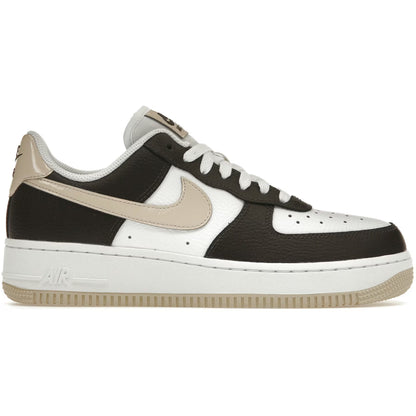 Black and white sneaker with a tan swoosh logo on a white background