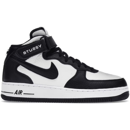 Black and white sneaker with Stussy branding on a white background