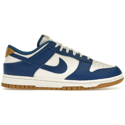 Blue and white sneaker with brown sole on a white background