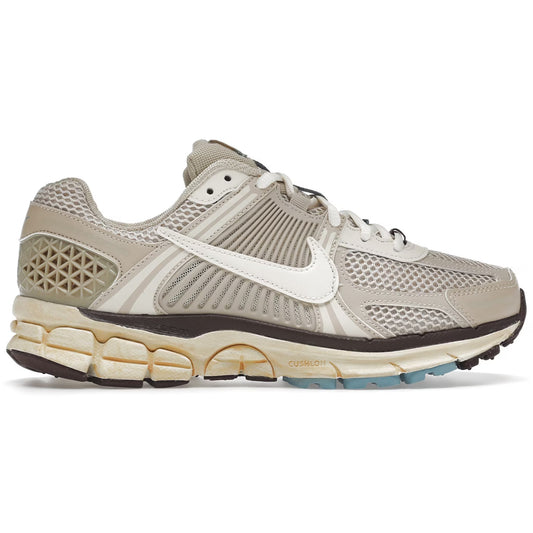 Beige running shoe with a white swoosh logo on a white background