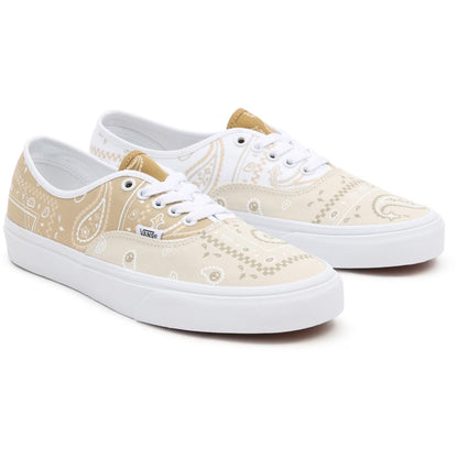 Pair of beige patterned sneakers with white soles on a white background