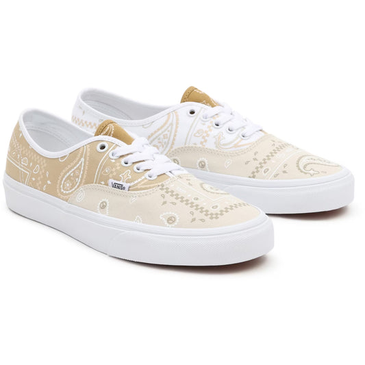 Pair of beige patterned sneakers with white soles on a white background