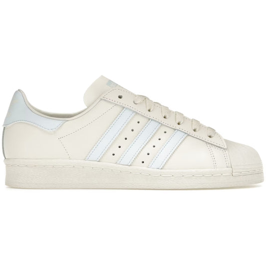 Beige sneaker with white stripes on a white background
