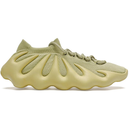 Light green sneaker with unique sole design on a white background