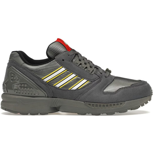 Gray athletic shoe with white stripes on a white background